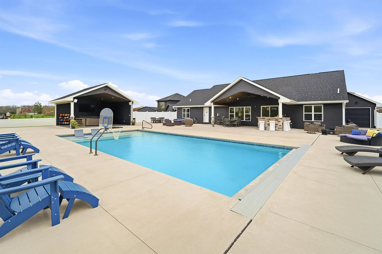 Pool with covered pavilion and basketball hoop