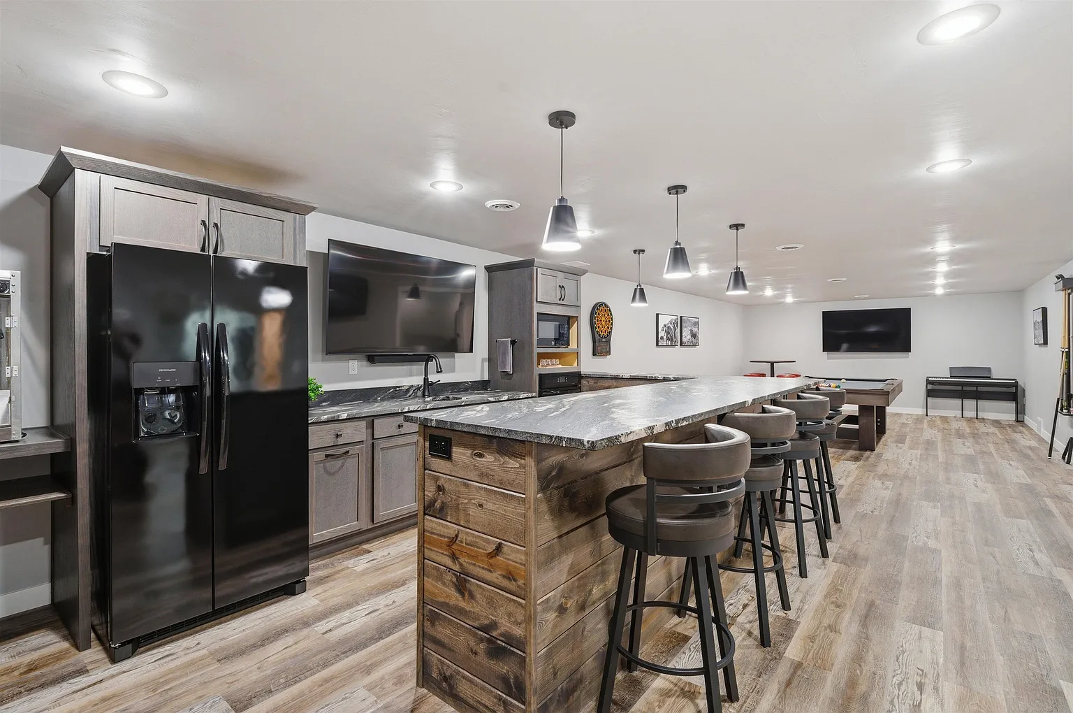 Wet bar with fridge and pool table beyond