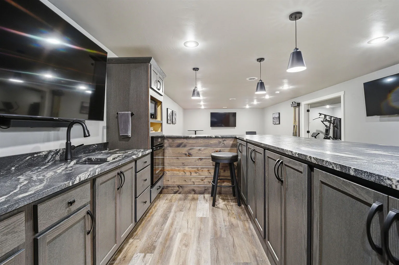 Bar kitchen with granite counters and built-in oven