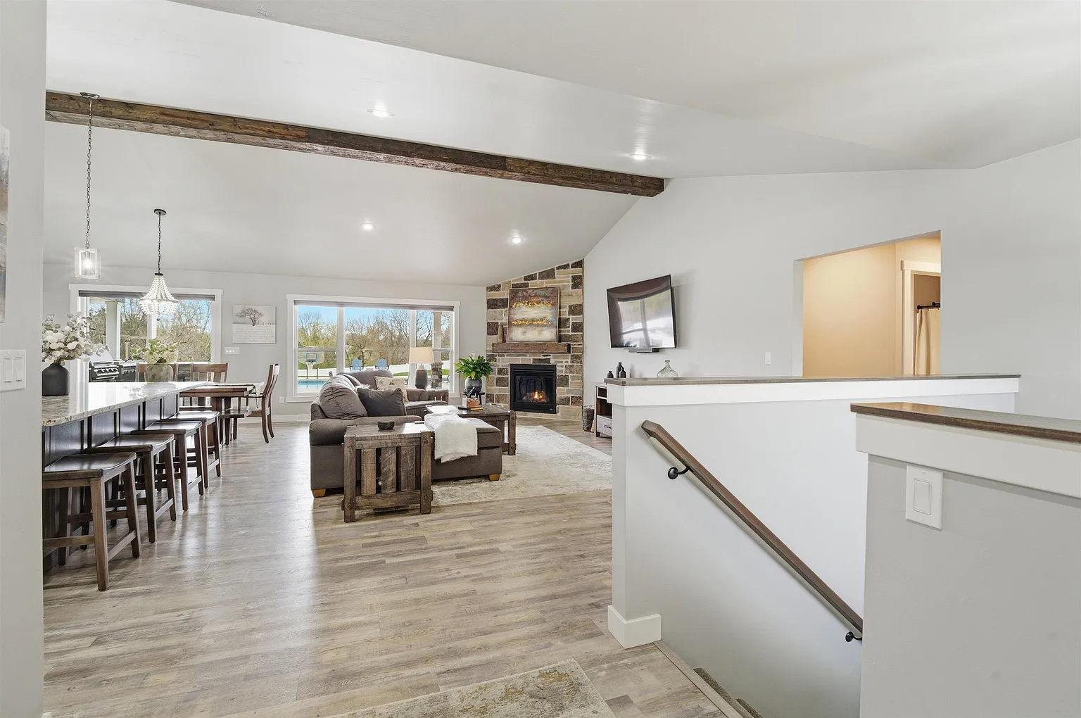 Great room with exposed beams and stone fireplace