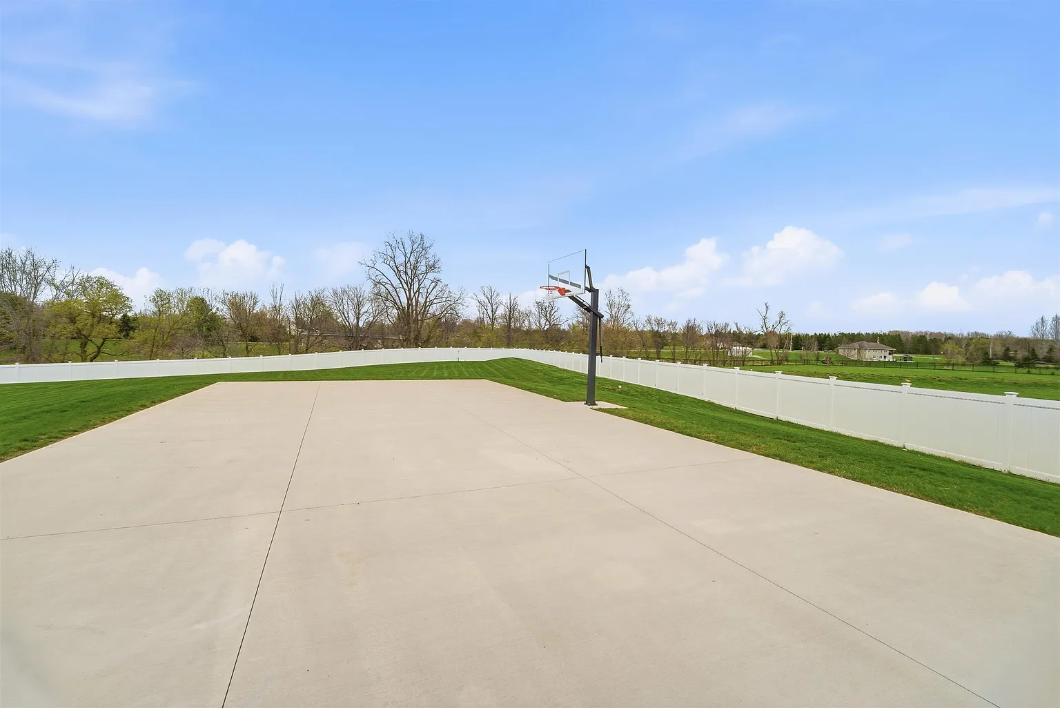 Full concrete sport court with basketball hoop