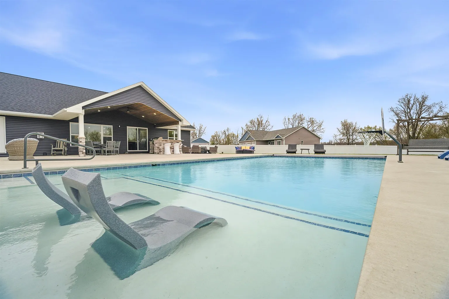 In-ground pool with tanning ledge and crystal-clear water